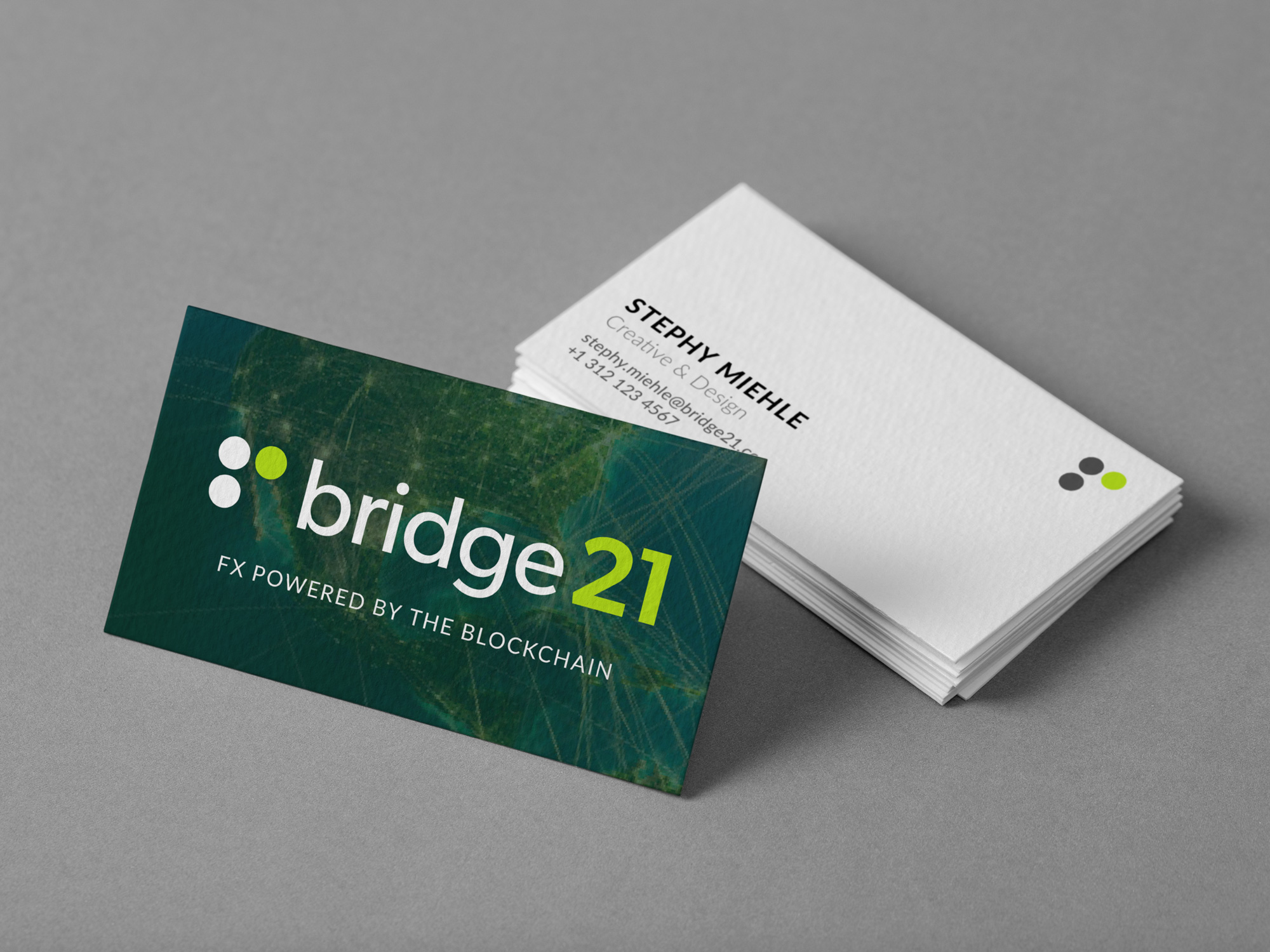 A set of bridge21 business cards, featuring the company logo and contact information.