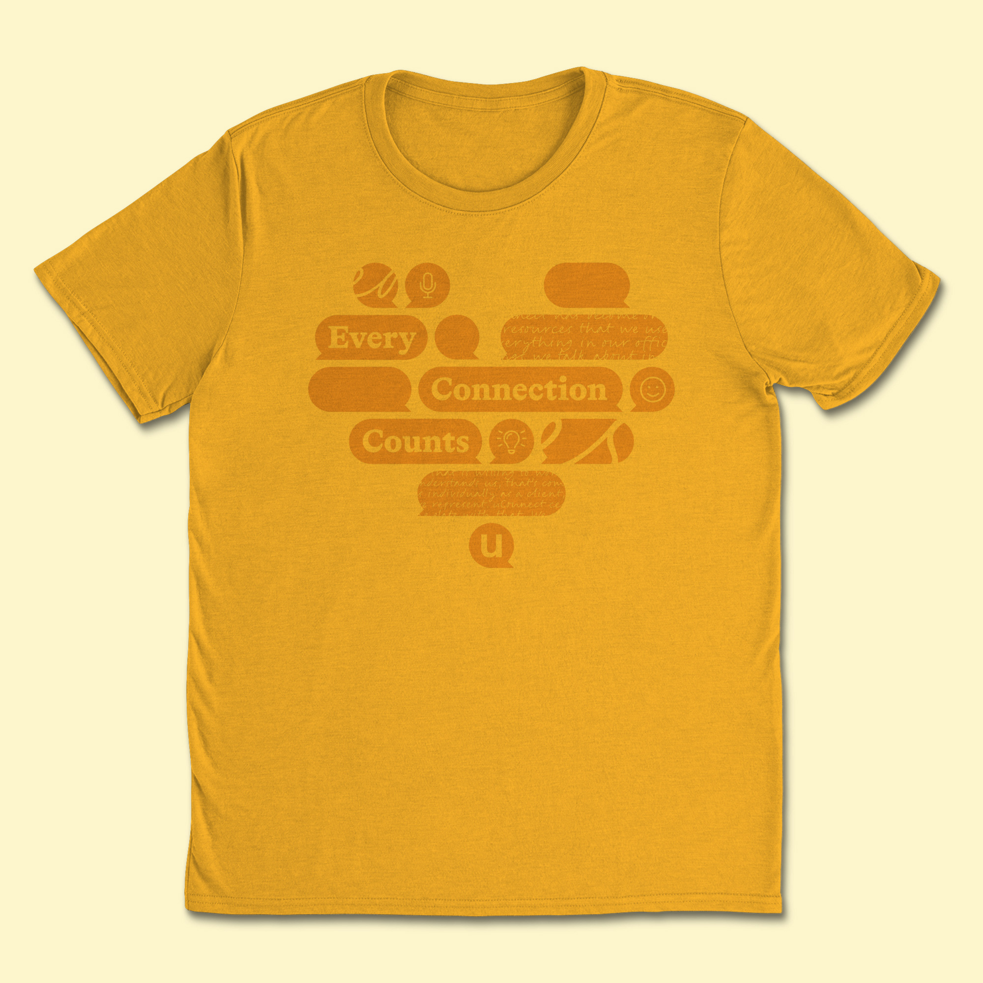 Gold t-shirt with many orange geometric quote bubbles forming a heart shape. Three wide bubbles say 'Every connection counts' and the remaining bubbles have a mix of icons, cursive handwriting, abstract lines, and blank designs.