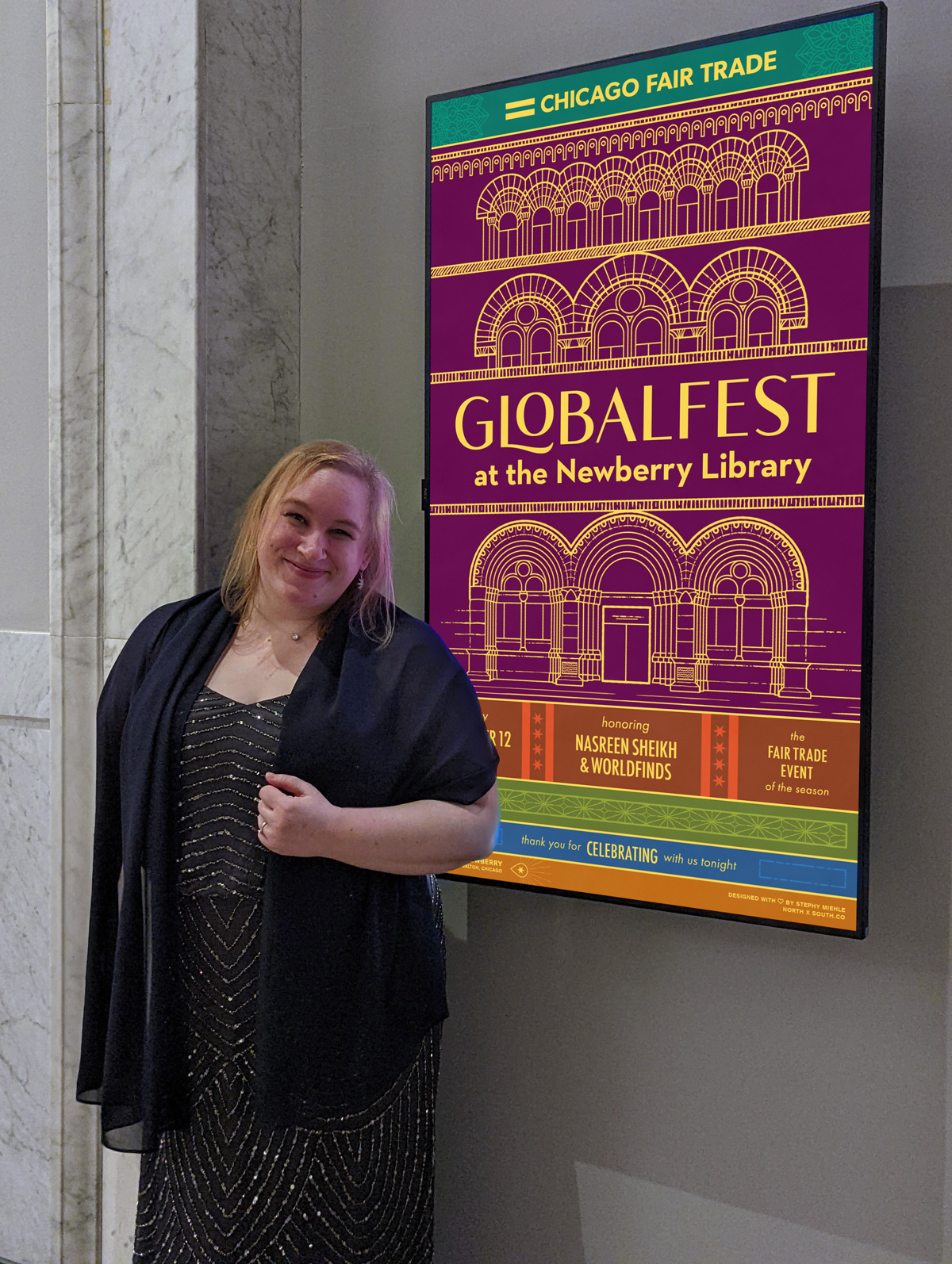 Stephy stands in front of a digital poster at the Newberry Library. Her vertical adaptation of the event poster is displayed on the screen.